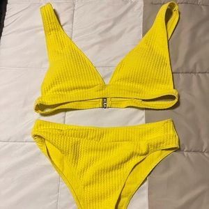 Large bright yellow swimsuit.